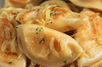 ambrosia salad in a bowl topped with a cherry