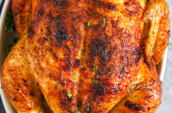 a cooked rotisserie chicken with parsley