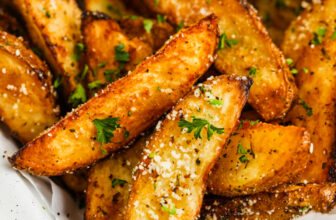 Air Fryer Potato Wedges topped with parsley and parmesan cheese
