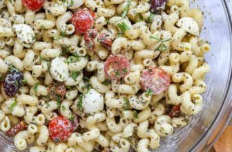 pesto pasta salad in a bowl with parsley