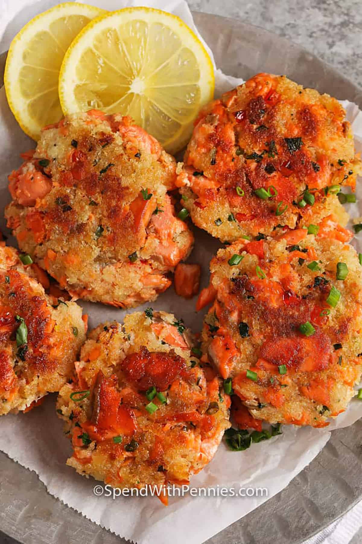 cooked Salmon Croquettes on a plate with lemon slices