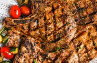 cooked Grilled Pork Chops with vegetables on a plate