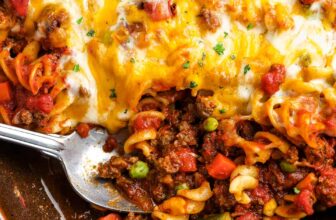 a casserole dish of baked hamburger casserole with a spoon