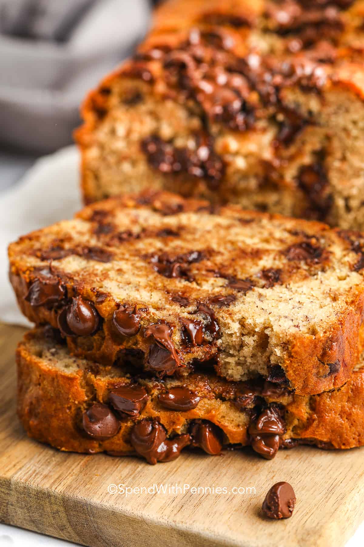 slices of chocolate chip banana bread on a wood board