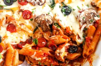 a serving spoon in a baked supreme pizza casserole