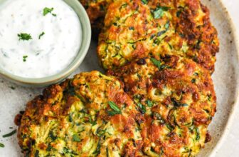 zucchini fritter patties on a plate with ranch