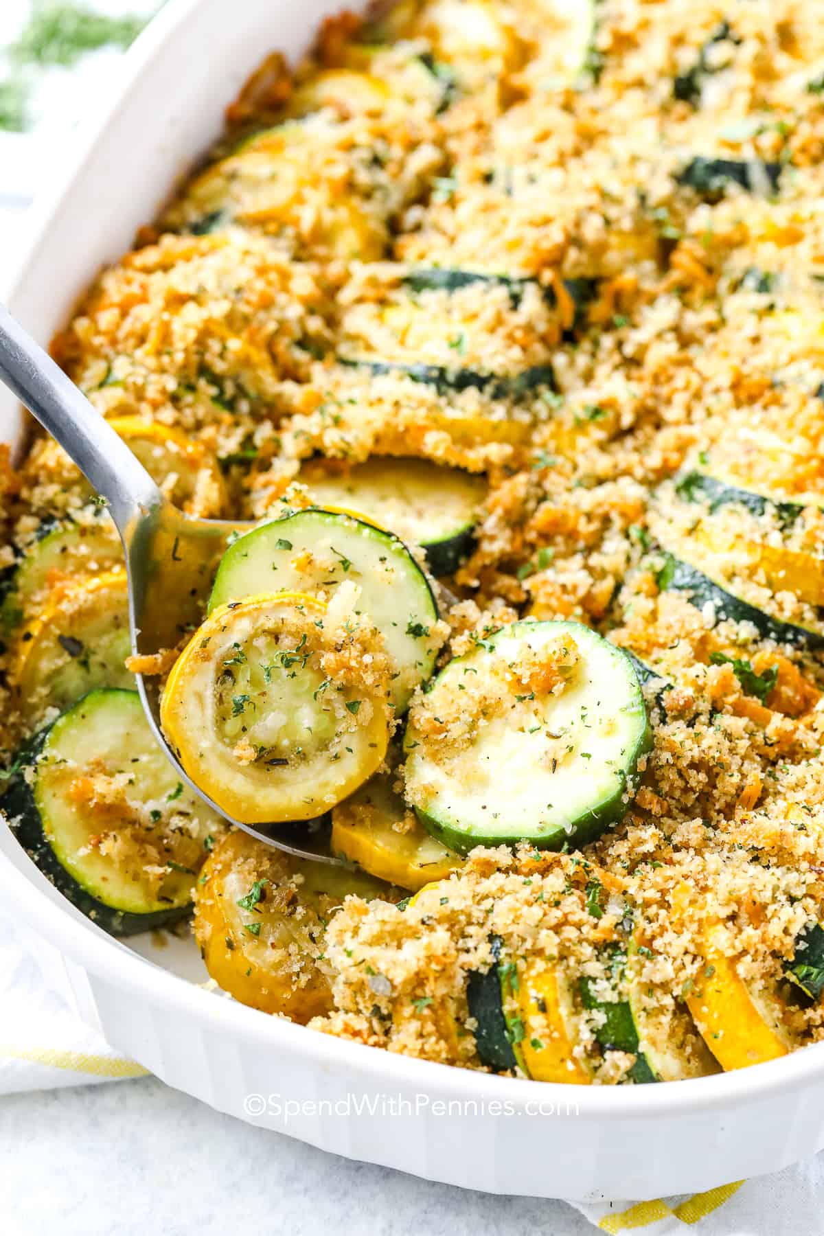 a spoon serving squash casserole