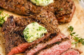 a bowl of caesar salad with lemons