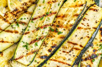 a plate of grilled zucchini with lemon slices