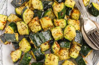 zucchini pizza bites on a pan with basil on top