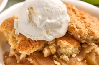 Apple cobbler topped with ice cream in a bowl