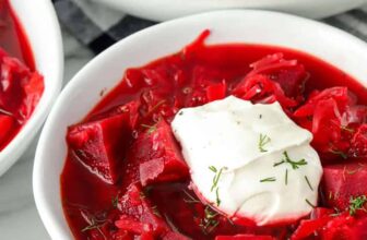 Apple cobbler topped with ice cream in a bowl