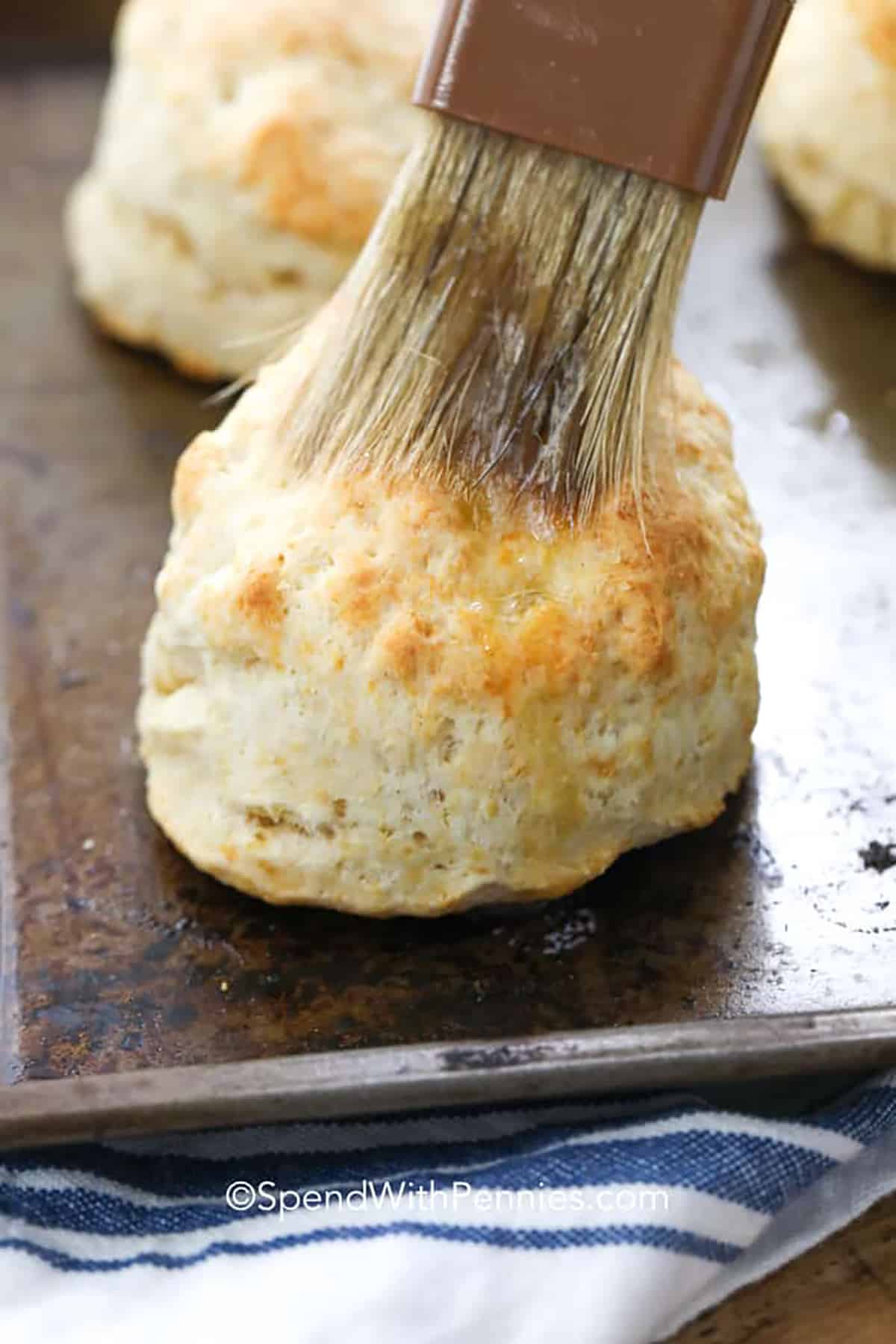 brushing butter on Homemade Biscuits
