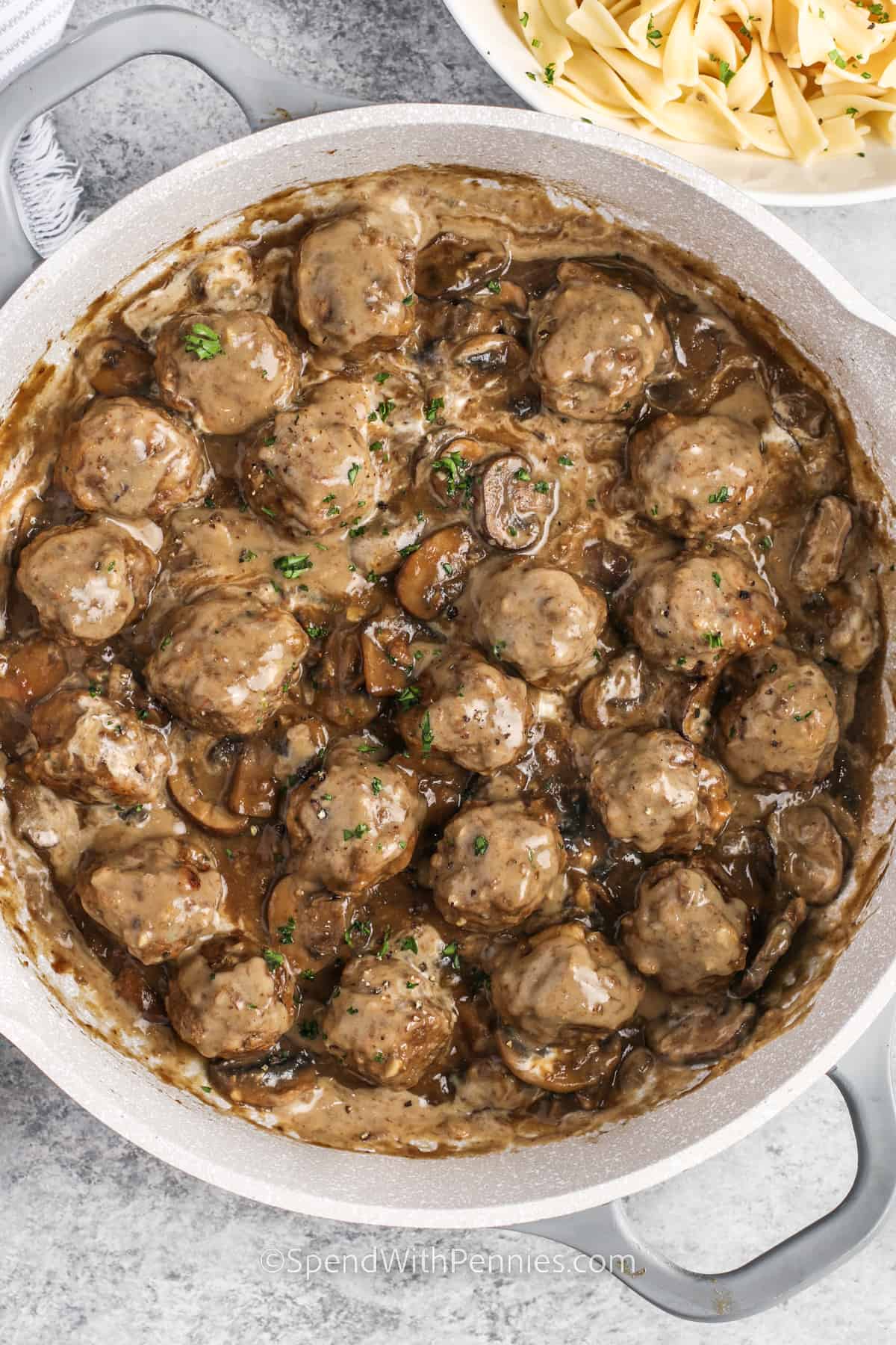 Meatballs in mushroom sauce in a frying pan