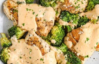 chicken and broccoli with cheese sauce on a serving plate