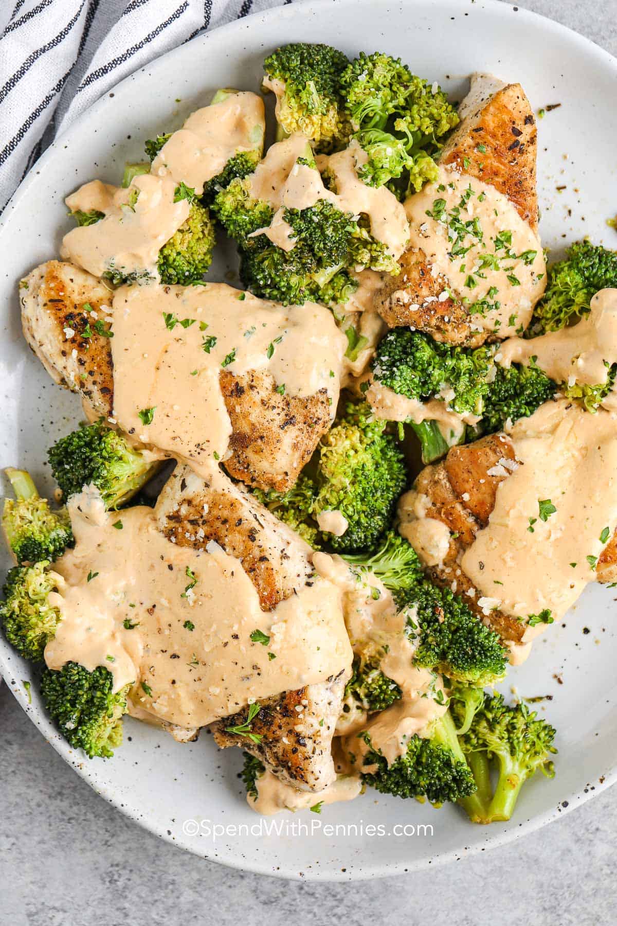 chicken and broccoli with cheese sauce on a serving plate