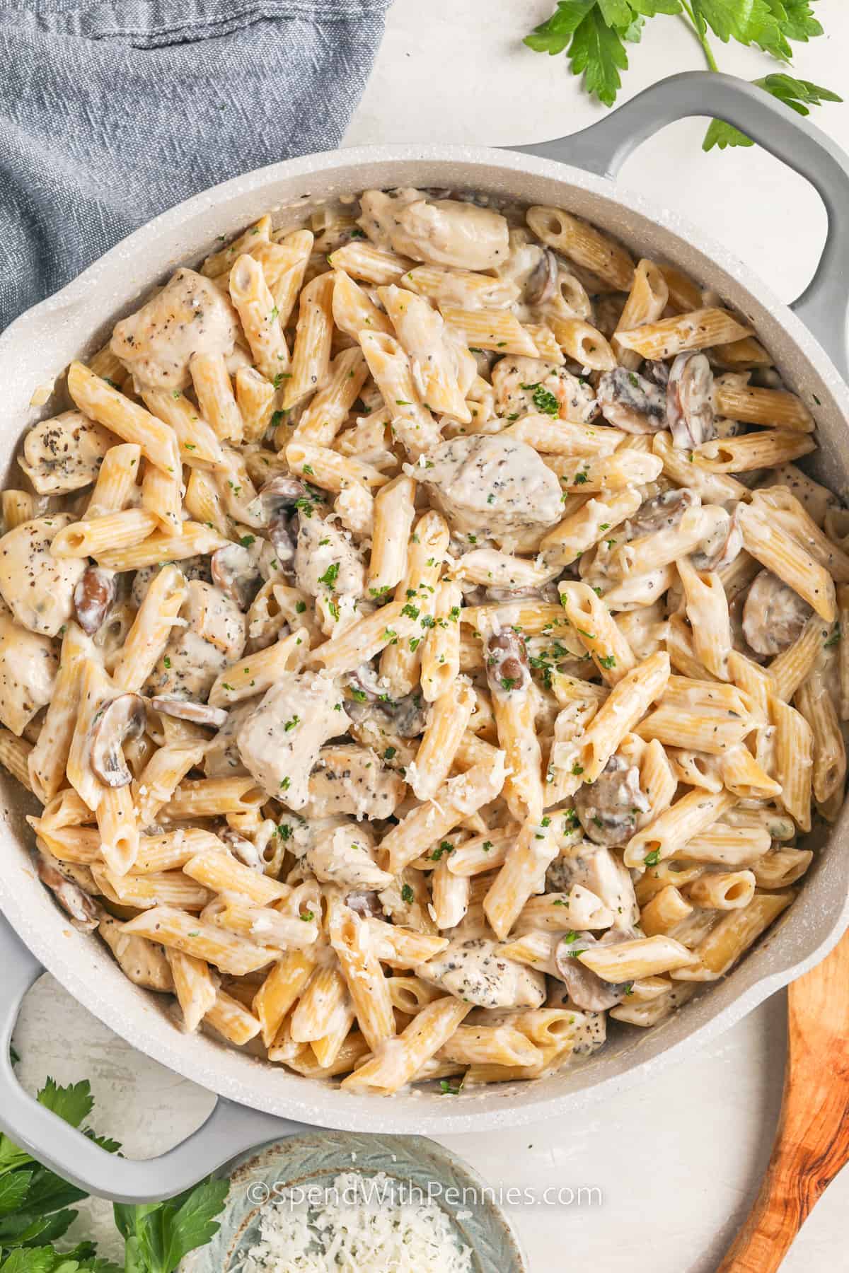 Mushroom chicken with pasta prepared in a frying pan