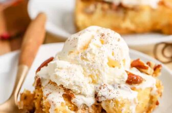 a slice of pumpkin crunch cake topped with ice cream