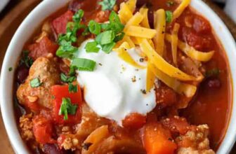 turkey chili in a white bowl with garnish