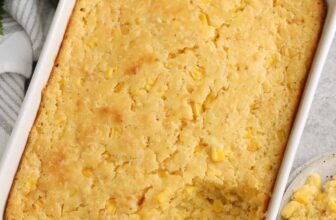 baked corn casserole in a white baking dish