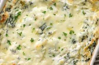 spinach artichoke dip in a white dish