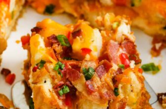 taking a piece of Overnight Breakfast Casserole out of the dish