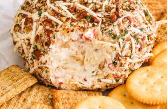 Pineapple Cheese Ball on a plate with crackers
