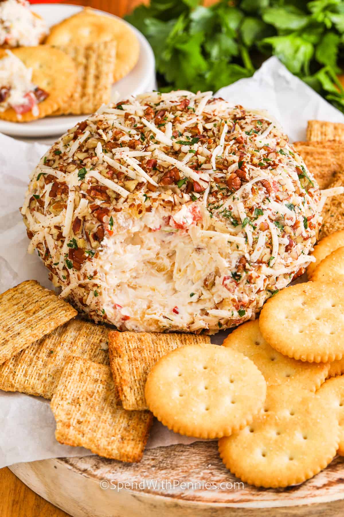 Pineapple Cheese Ball on a plate with crackers