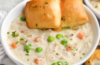 instant pot chicken pot pie soup in a bowl with buns