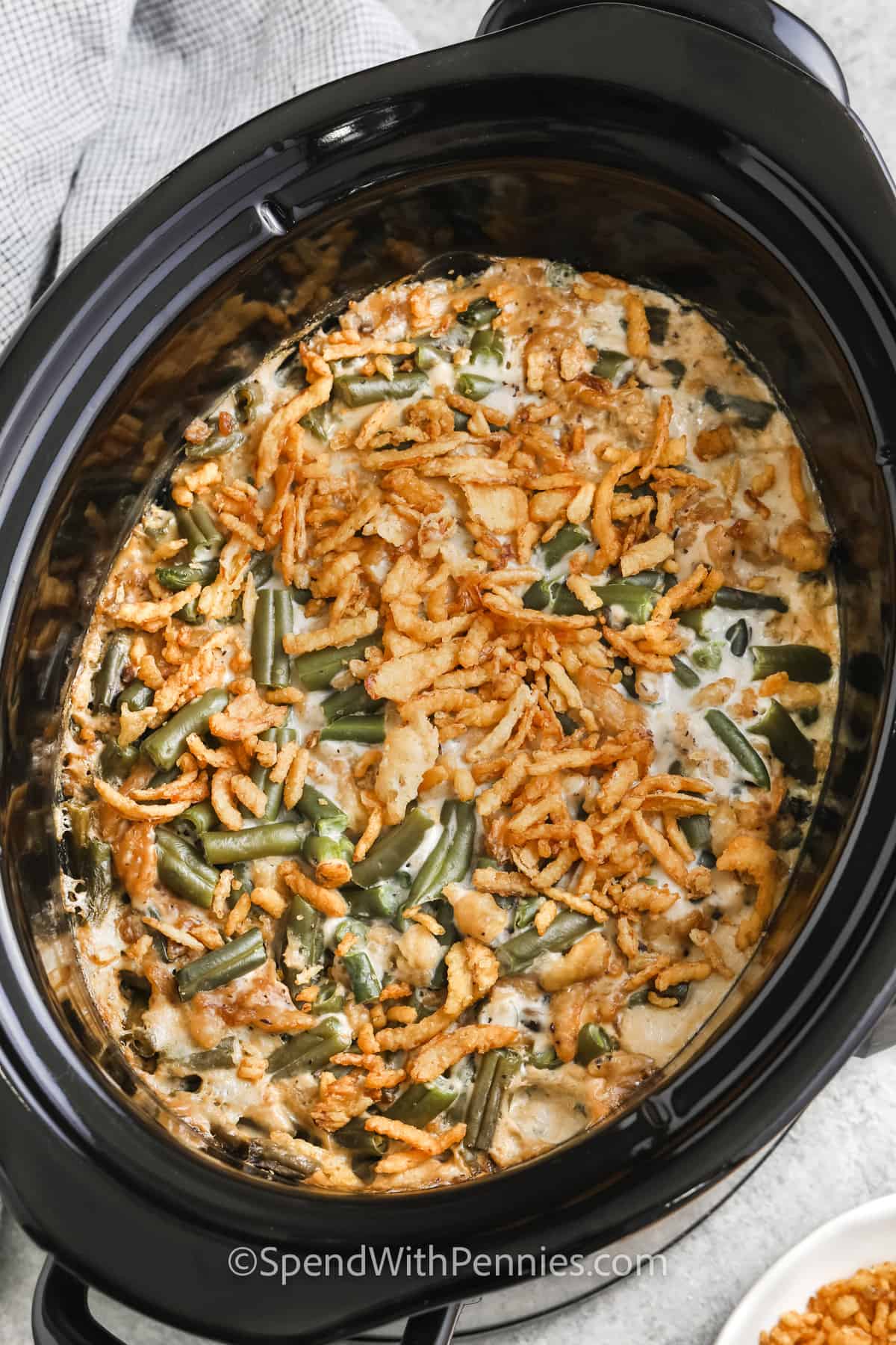 A classic chicken salad on a roll with tomatoes and lettuce next to cucumbers.