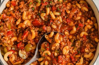 pot full of American Goulash with a spoon