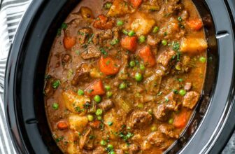 crockpot beef stew in a slow cooker garnished with parsley