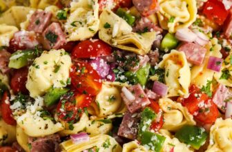 close up of Italian Tortellini Salad on a plate with a spoon and fork