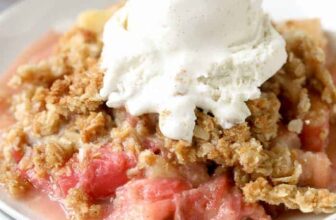 Rhubarb Crisp served on a white plate with ice cream on top